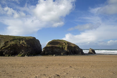 Rocks on beach against sky