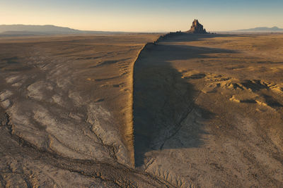 Scenic view of shiprock against sky during sunset