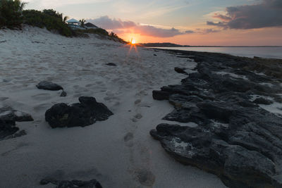 Scenic view of beach against sky during sunset