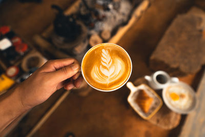 Hand holding coffee cup