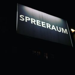 Low angle view of information sign at night