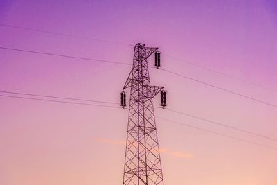 Low angle view of electricity pylon against clear sky