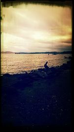 Scenic view of sea against cloudy sky