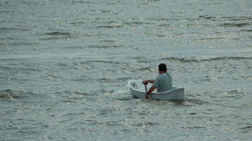 Full length of man sitting at beach