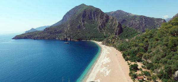 Scenic view of sea and mountains against sky