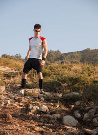 Full length of young man running on field