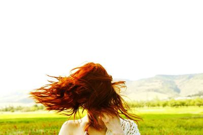 Woman with umbrella on field