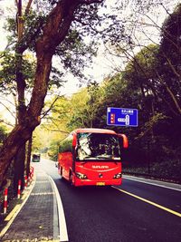 Red car on road against sky