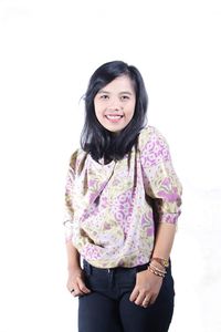 Portrait of a smiling young woman against white background