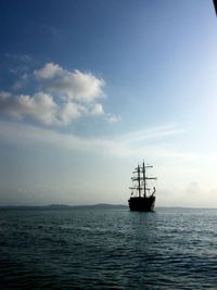 Sailboat sailing in sea against sky