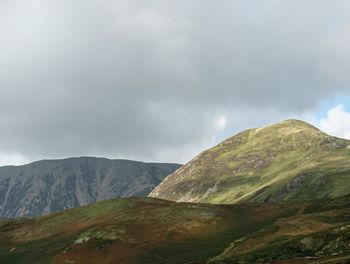 Scenic view of mountains against cloudy sky
