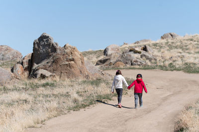 Children hiking on dirt road