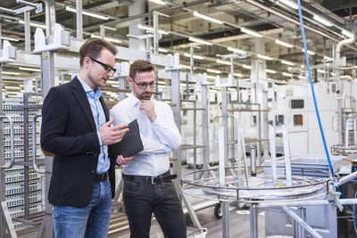 Two men talking in factory shop floor