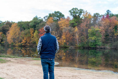 Rear view of man standing by trees