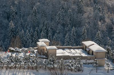 Snow covered chairs on field against snowcapped mountains during winter