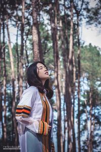 Woman standing in a forest