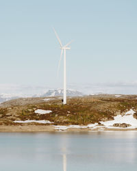 Low angle view of windmill against sky