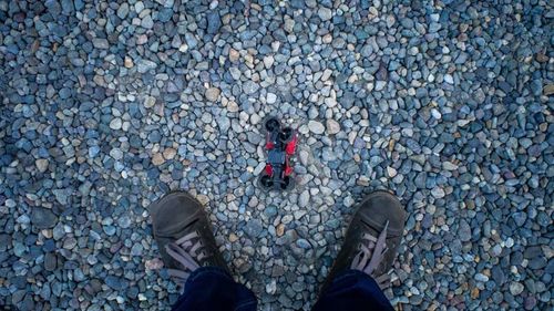 Low section of person standing on tiled floor