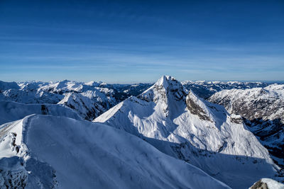 Scenic view of snowcapped mountains against sky