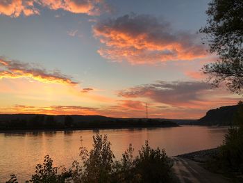 Scenic view of lake against orange sky