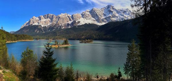 Scenic view of lake and mountains against sky