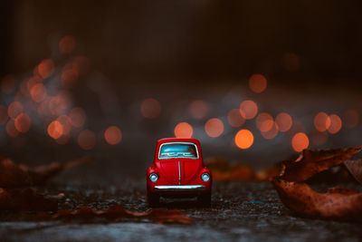 Close-up of toy car on street at night