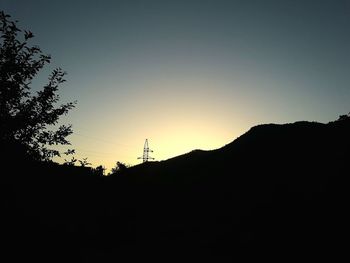 Silhouette mountain against clear sky during sunset