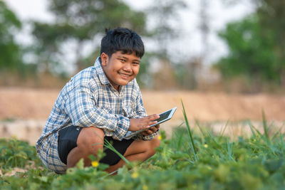 Young man smiling on field