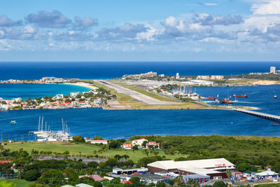 High angle view of sea and buildings against sky