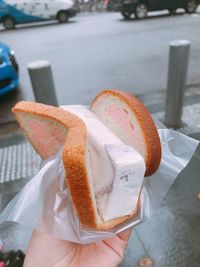 Close-up of hand holding ice cream cone