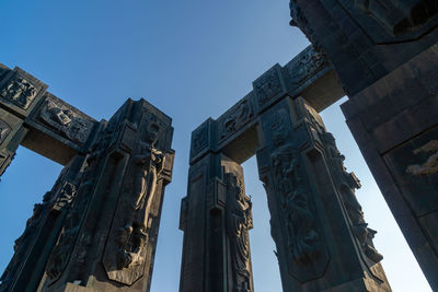 Low angle view of buildings against clear blue sky