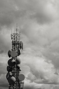 Low angle view of communications tower against sky