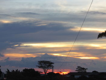 Low angle view of silhouette trees against sky at sunset