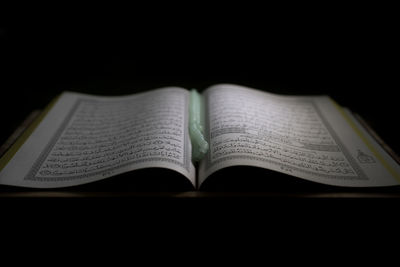 Close-up of open book against black background