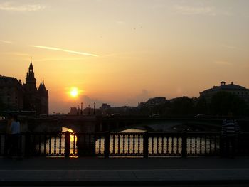 Bridge over river at sunset