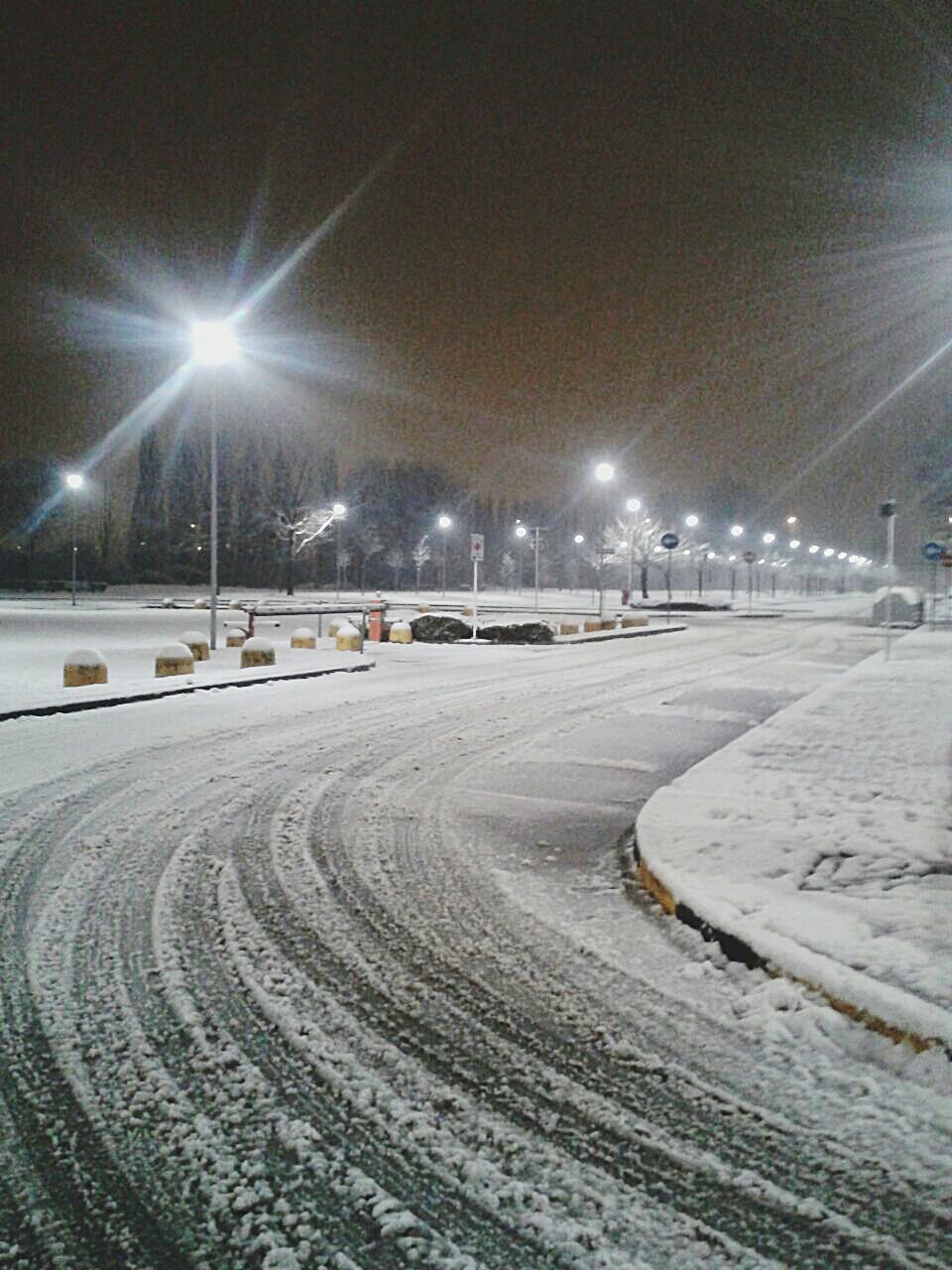 illuminated, night, street light, transportation, lighting equipment, the way forward, road, street, snow, winter, cold temperature, empty, sky, diminishing perspective, weather, mode of transport, electricity, outdoors, no people, city