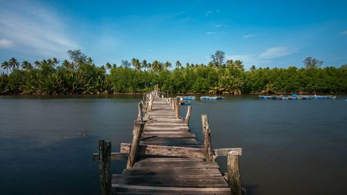 Pier over lake against sky