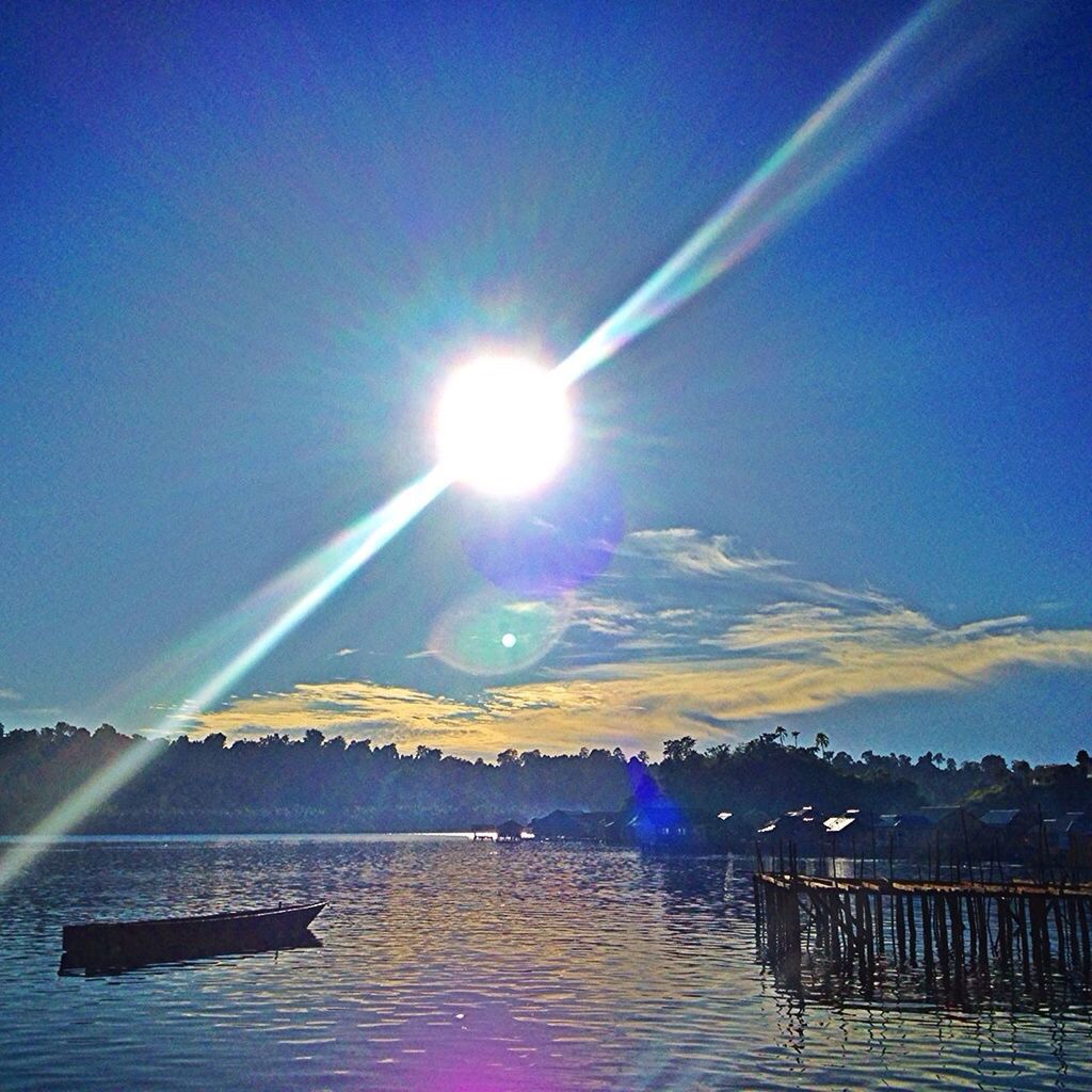 sun, sunbeam, lens flare, water, blue, sunlight, scenics, tranquility, sky, clear sky, tranquil scene, beauty in nature, nature, transportation, sunny, bright, built structure, copy space, reflection, mountain