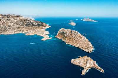 High angle view of rocks in sea against sky