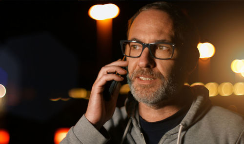 Close-up of mature man talking on mobile phone