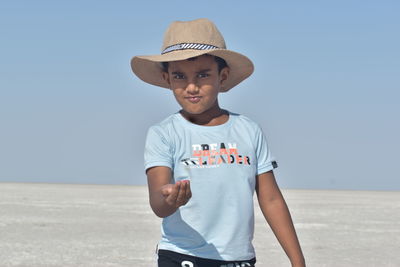 Portrait of boy standing at beach