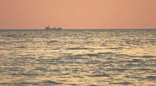 Scenic view of sea against clear sky during sunset