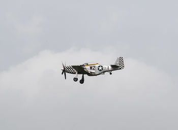 Low angle view of airplane flying against sky