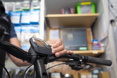 Close-up of man holding bicycle