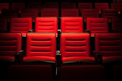 Full frame shot of empty red seats in auditorium