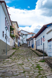 Street amidst buildings against sky