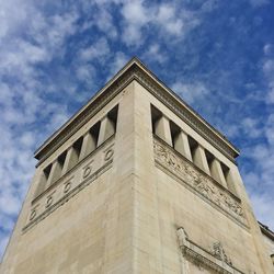 Low angle view of building against cloudy sky