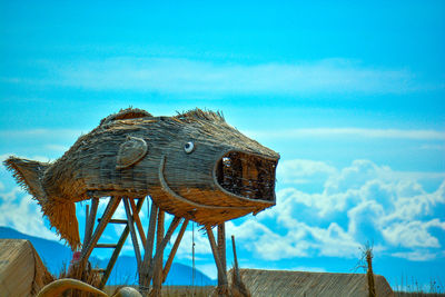 Close-up of traditional windmill against blue sky