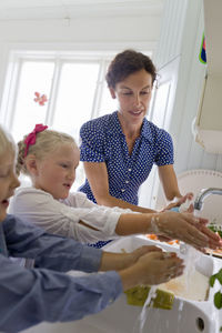 Mother and kids washing hands