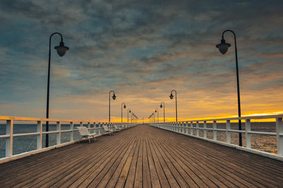 Street lights on bridge at sunset